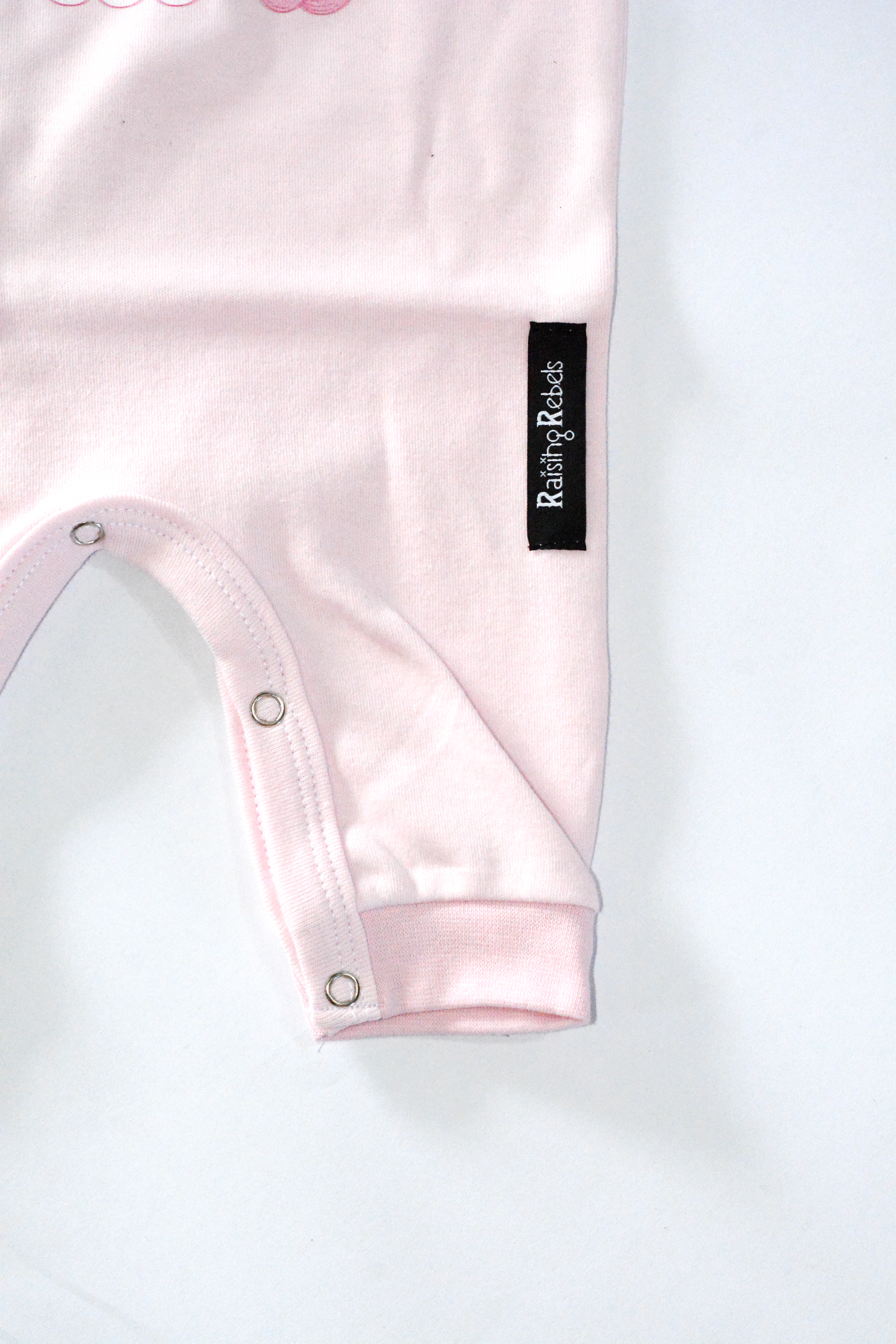 Pink Romper with Raising Rebels Logo and Button detail